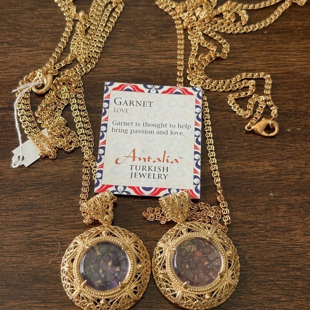 Two Gold Pendant Necklaces with garnet and amethyst